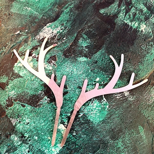 Close-up of pink acrylic reindeer antler cake toppers for Christmas party dessert decor