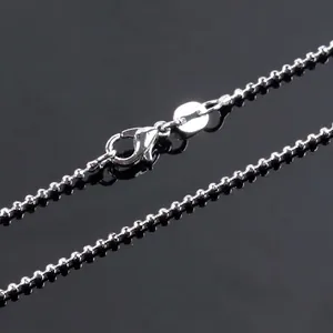 Cute kitten pendant necklace with silver ball chain and secure lobster clasp on black background