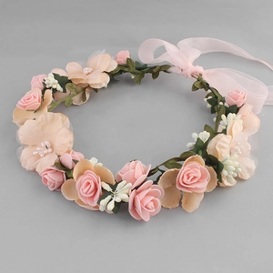 Detail of fabric pink roses and orange flowers on a bridal wreath with chiffon ribbons