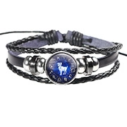 Detailed view of black braided leather Aries zodiac bracelet with a glass charm pendant