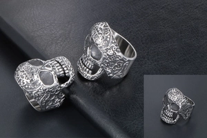 Macro view of vintage skull rings with intricate baroque embossing and oxidized finish