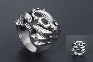 Macro detail of gothic skull ring with wing carving in vintage silver finish