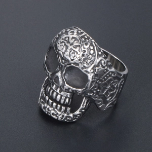 Vintage gothic skull ring with intricate floral carvings in antique silver finish