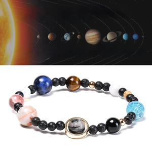 Detail of natural stone galaxy bracelet with planets and elastic cord for unisex wear