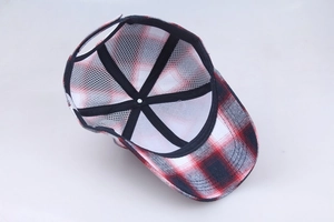 Macro shot of red and black checkered baseball cap interior with white mesh lining