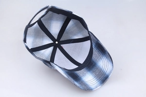 Detail view of the breathable white mesh interior and blue plaid pattern of this baseball cap