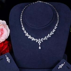 Detailed close-up of sparkling AAA zircon necklace and earrings on a jewelry display stand