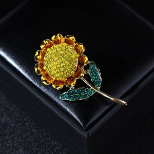 Detailed macro shot of sunflower brooch featuring sparkling yellow and green rhinestones