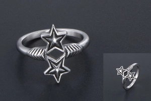 Detailed close-up of double star silver ring featuring vintage textured bands and black background