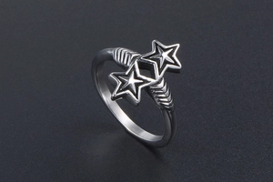 Macro shot of silver metal twin star rings with vintage design and polished finish