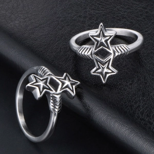 Retro silver star rings with wing textures on black leather background