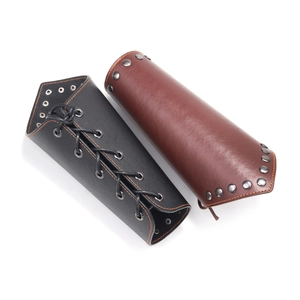 Punk style braided leather wrist guards in black and brown with lacing and stud details
