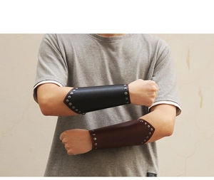 Detail of punk leather wrist guards with metal rivets in black and dark brown finish
