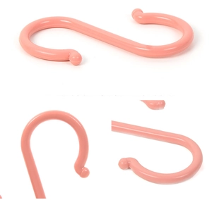 Close-up of pink S-shaped plastic hooks with rounded anti-slip ends for home storage