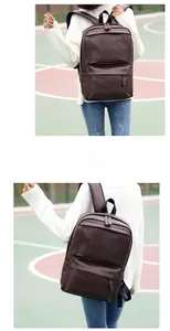 Detail view of premium dark brown PU leather backpack with sleek zippers in outdoor setting