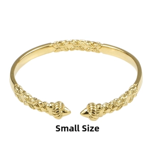 Detail of 18K gold-plated open bangle with woven texture and conical spiral caps