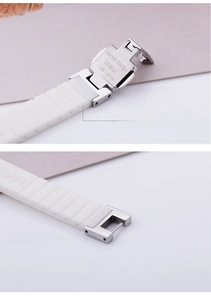 Detail of white silicone strap with silver butterfly buckle and adjustable textures