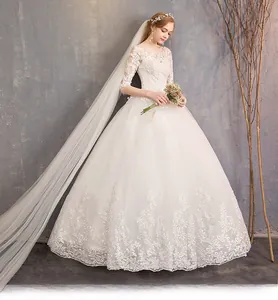 Detail of floral lace embroidery on long sleeves and bodice of white wedding dress