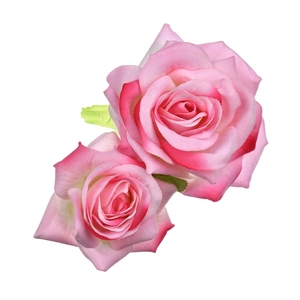 Close-up of pink velvet rose hair clip with gradient petals and green leaves detail