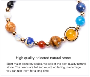 Macro detail of natural stone galaxy beads and golden spacers on a solar system bracelet