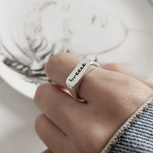 Minimalist 925 sterling silver rectangular signet ring with Breeze engraving on hand