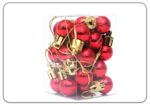 Set of 24 mini red glossy Christmas tree ornaments in a clear box with gold hanging strings