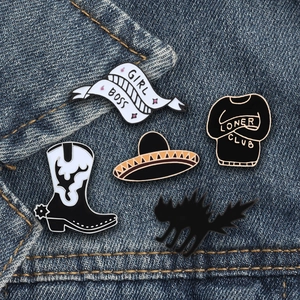 5-piece black punk enamel pin set with cat and boot designs on dark denim jacket