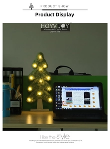 Detail of a plush glowing Christmas tree with LED ball lights and a light wood base stand