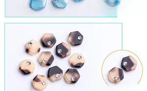 Detailed view of hexagonal faux tortoise shell nail charms with a sparkling center diamond