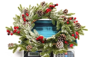 Detailed view of frosted Christmas wreath with pine cones weighing 0.53kg on a scale