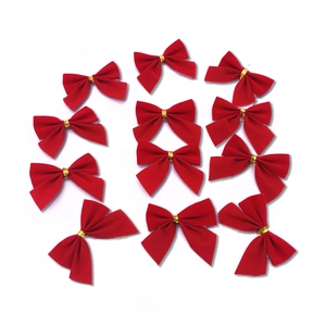 Detail view of 12 red flocked Christmas bows with gold ties in a matrix arrangement
