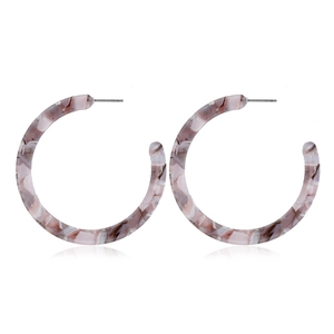 Detailed close-up of C-shaped resin earrings with pink and grey marble texture patterns
