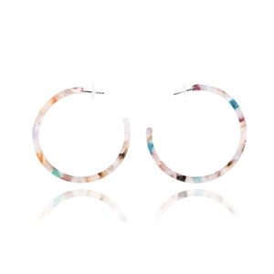Detail of C-shaped acrylic earrings featuring a vibrant multicolored terrazzo pattern