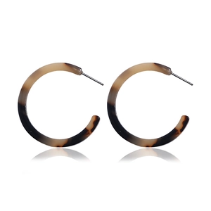 Detailed close-up of tortoise shell pattern acrylic C-shaped earrings with metal pins