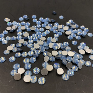 Detailed view of scattered light blue flatback rhinestones for nail art decoration