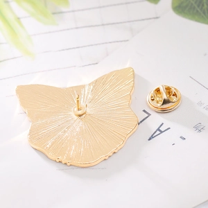 Macro detail of golden leopard head brooch back with secure butterfly clasp closure