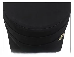 Detail of reinforced stitching on black military cap crown with a metallic logo