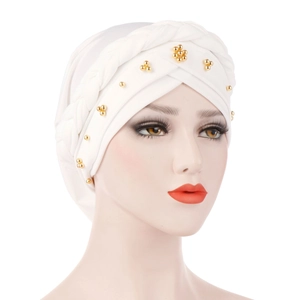 Close-up of white milk silk turban featuring braided twist and gold bead embellishments