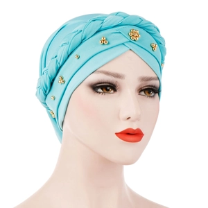 Detail of teal milk silk turban hat featuring braided design and golden floral bead accents