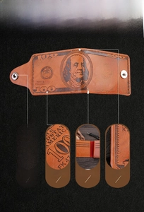 Macro detail of brown leather wallet with dollar bill pattern and metal snap closure