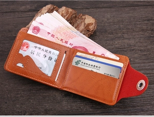 Interior detail of a brown leather bifold wallet featuring multiple card slots and sections