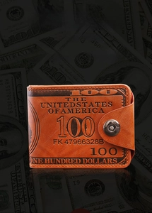 Close-up of vintage brown leather wallet with embossed US dollar bill patterns and snap