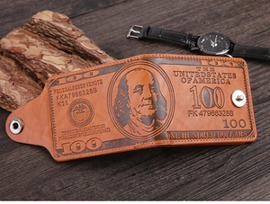 Detailed close-up of brown leather wallet with vintage US dollar bill embossed pattern
