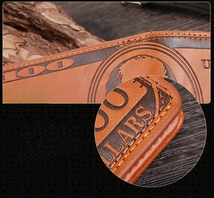 Macro view of tight precision stitching and vintage dollar pattern on brown leather wallet