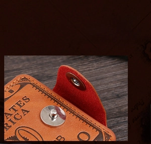 Detailed macro view of a brown leather wallet with silver magnetic buckle and red lining