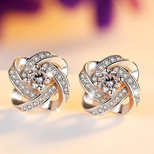 Macro shot of silver twisted flower stud earrings with sparkling zircon crystals