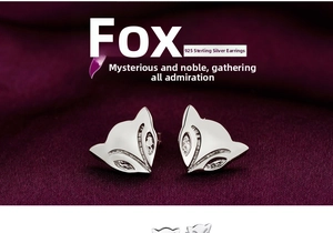 Detailed macro view of diamond-set fox earrings on a luxury velvet texture