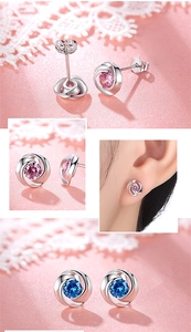 Detail of floral stud earrings with pink and blue crystals showing on-ear placement