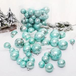 37-piece mint green pearl Christmas ball ornament set displayed on a white fabric surface