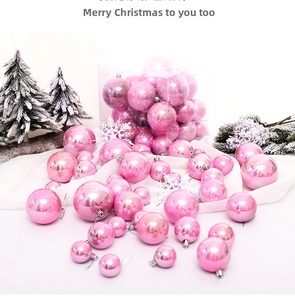 Detail of pink pearlized Christmas ball ornaments with hanging hooks and festive scenery